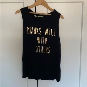 Black sleeveless top with gold lettering size M